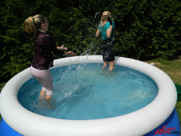 Одетые лесбиянки промокают насквозь после того, как залезают в наземный бассейн
